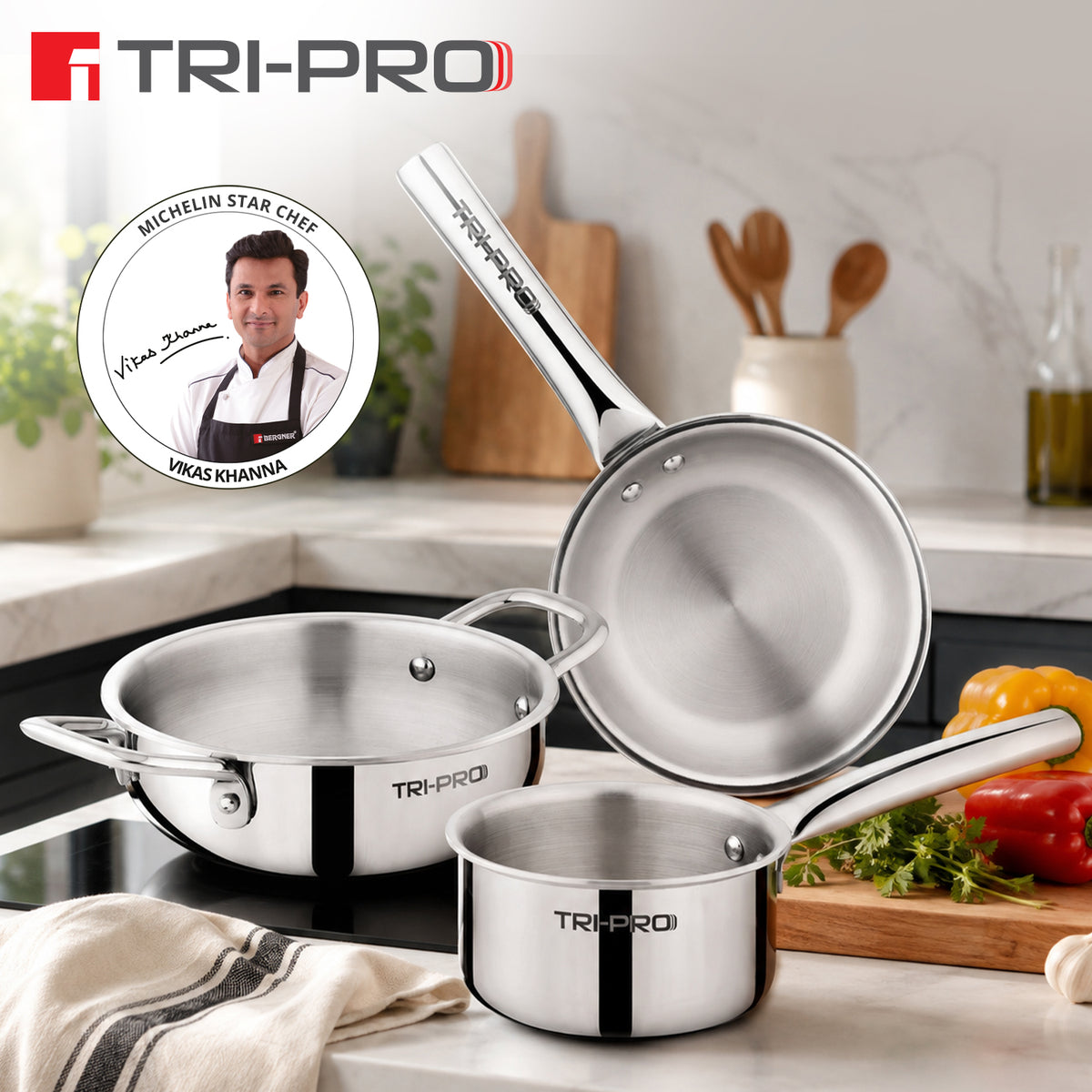 Tri-Pro Mini 3 piece tri-ply stainless steel cookware set featuring 14cm kadai, 12cm saucepan, and 14cm frypan on a kitchen countertop, endorsed by Michelin Star Chef Vikas Khanna