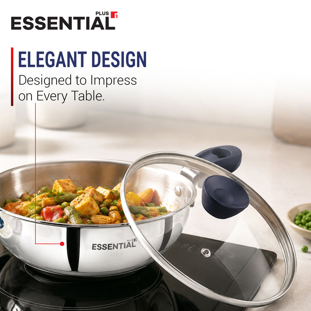 Stainless steel cookware set from ESSENTIAL Plus IT, featuring a pan with food cooking on a stovetop and a glass lid leaning beside it on a black burner. The image includes marketing text reading 'ELEGANT DESIGN' and shows a softly blurred kitchen background.