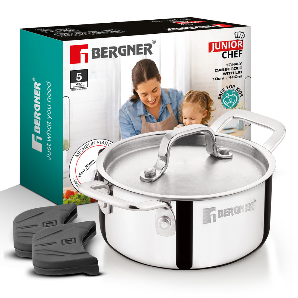 Bergner Junior Chef 10cm deep saucepan with lid, shown with its retail box and two black silicone trivet pads on a white background.
