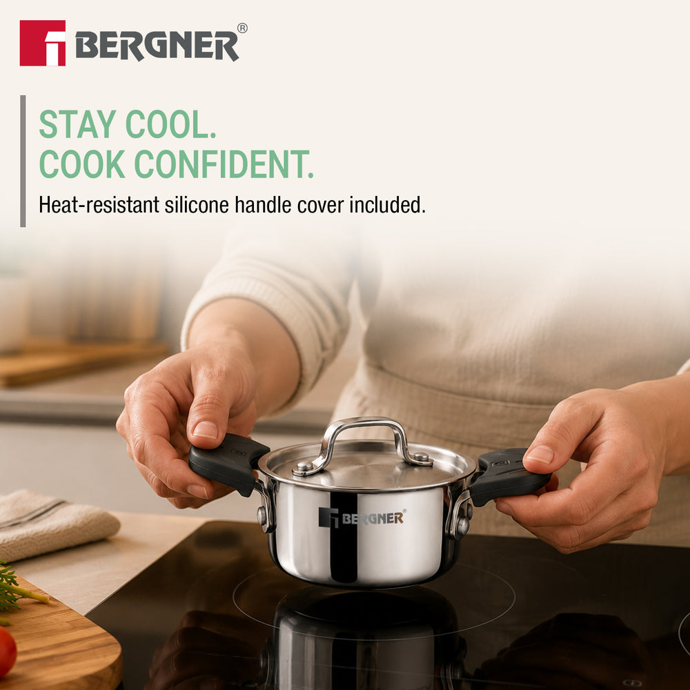 A person in a kitchen holds a small stainless steel Bergner saucepan with black silicone handle covers over a black induction cooktop. Text on the left reads 'STAY COOL.